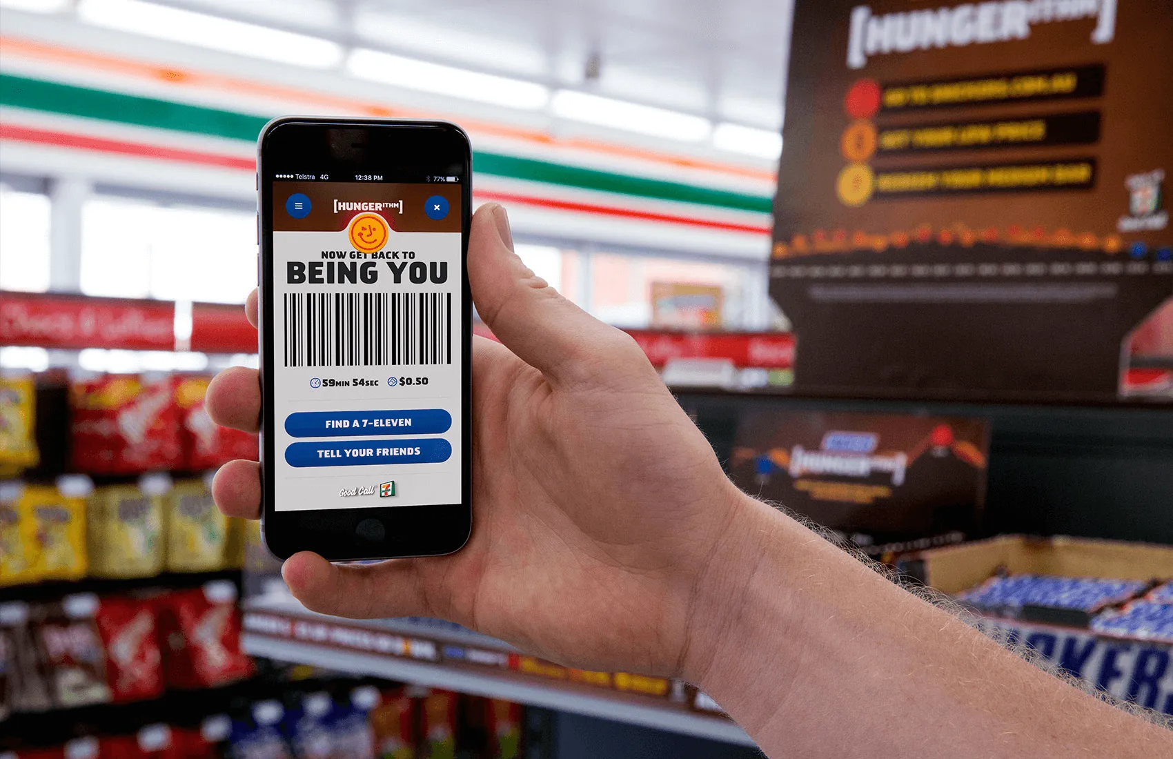 Photo of a man holding a smartphone, with a redeemed Snickers coupon on the screen